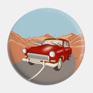 Red vintage car on the highway  in the desert and mountains. Pin