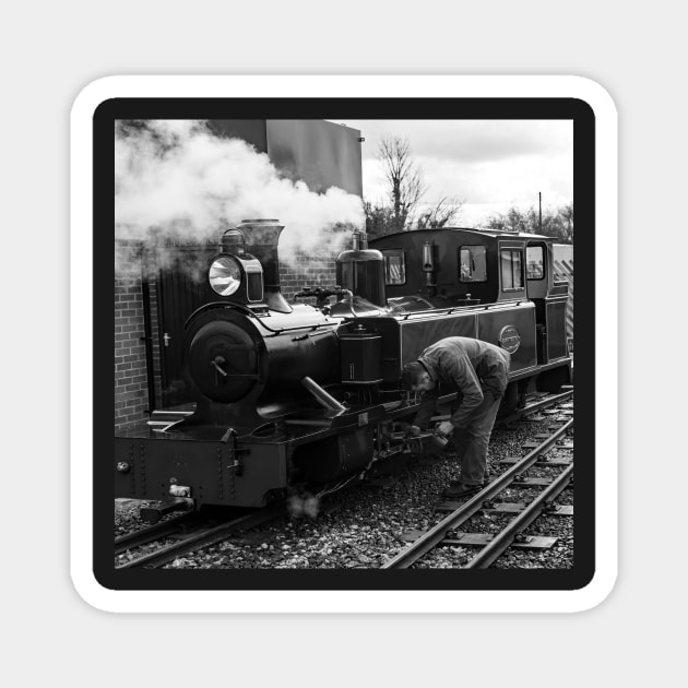Engineer attending to a steam train on the Bure Valley Railway Magnet by yackers1
