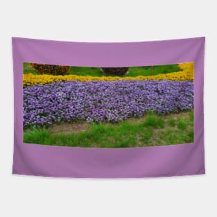 Purple Tulips with yellow flowers and green grass Tapestry