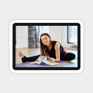 Young woman reading a yoga book Magnet