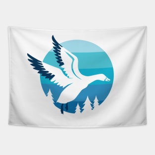 Snow Goose flying over pine trees Tapestry