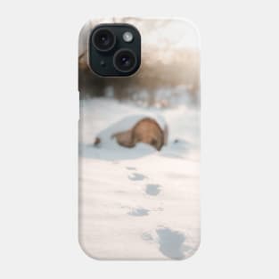 Footsteps in snow, tree trunk and sunset in background Phone Case