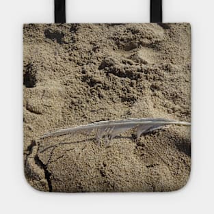 A seagull feather on the sand Tote