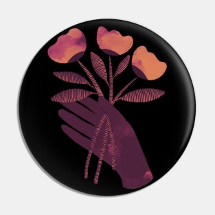 Brown hand with brown orange and pink flowers on black background Pin