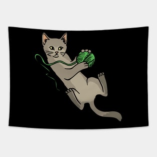 A cute cat playing with a green woolball Tapestry