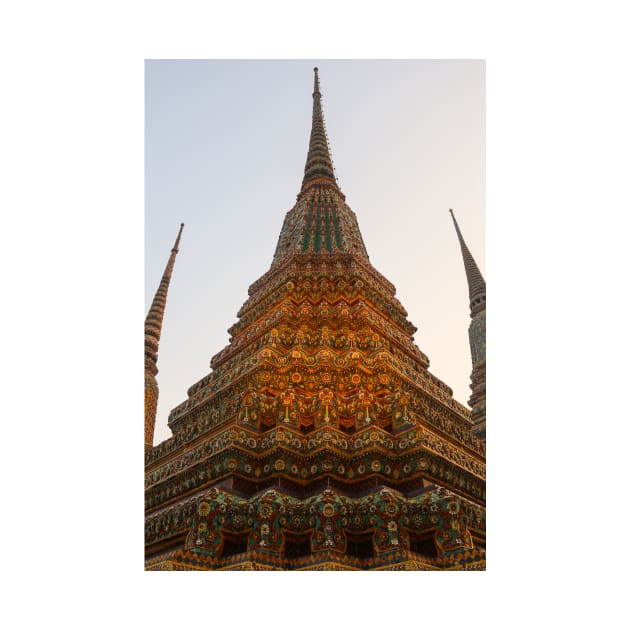 Low angle view of a Buddha stupa reaching symmetrical in the clear sky. by kall3bu