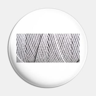 Closed up image of gray textile Pin