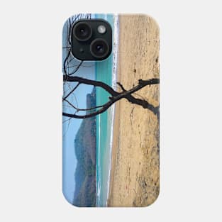 View through two curved pine tree trunks to a sand beach Phone Case