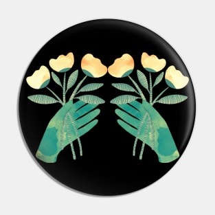 Green hands with yellow flowers for you on black background Pin