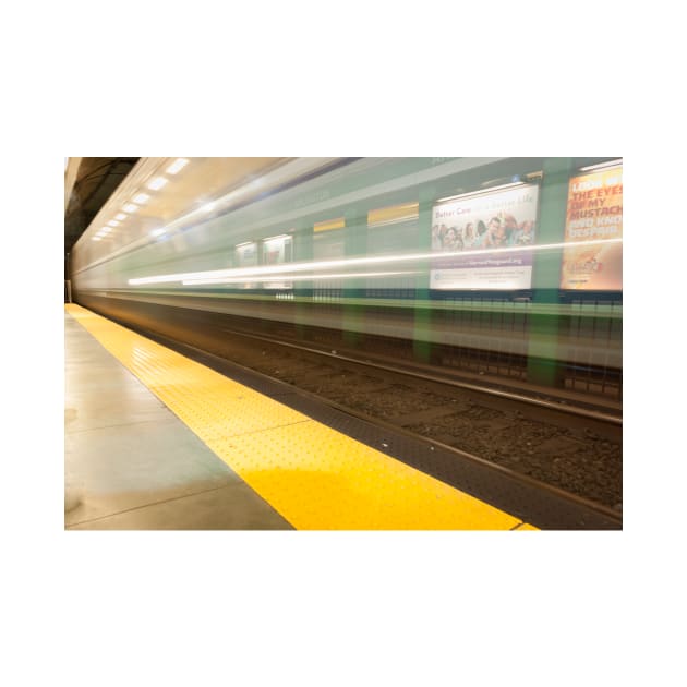 Platform with yellow line railway tracks blurred in motion blur aws train passes. by brians101