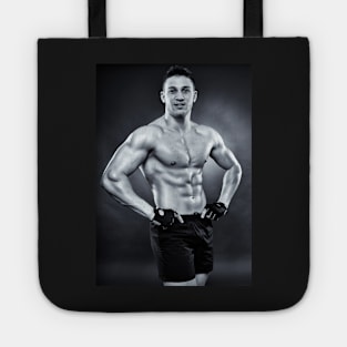 Handsome athletic man standing akimbo Tote