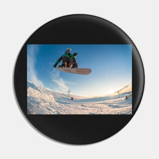 Snowboarder jumping against blue sky Pin