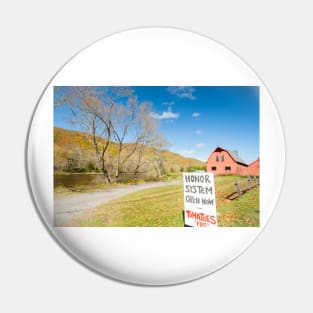 Honor system sign for tomatoes in rural New England beside an American style red barn by a river. Pin