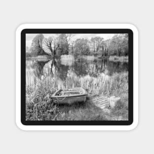 Boat on the bank of a rural lake in the Norfolk countryside, UK Magnet