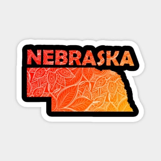 Colorful mandala art map of Nebraska with text in red and orange Magnet