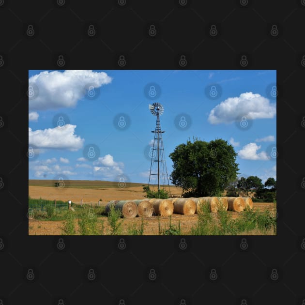 Kansas Windmill with Hay Bales and sky. by ROBERTDBROZEK