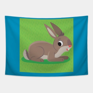 brown rabbit lies on a grassy meadow Tapestry