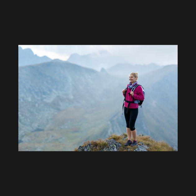 Woman backpacker hiking on a trail by naturalis