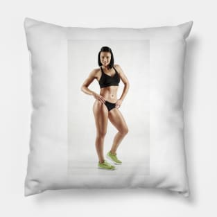 Young female fitness model on white Pillow