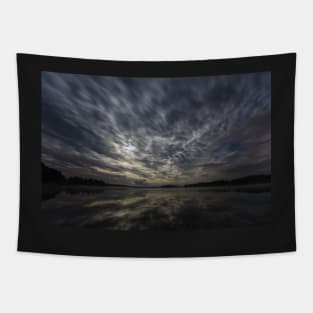 Dynamic clouds in the night over the lake lit by full moon Tapestry