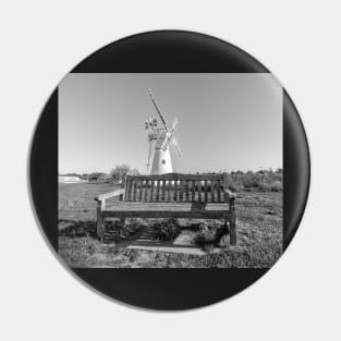 Wooden bench and traditional windmill on the riverbank Pin