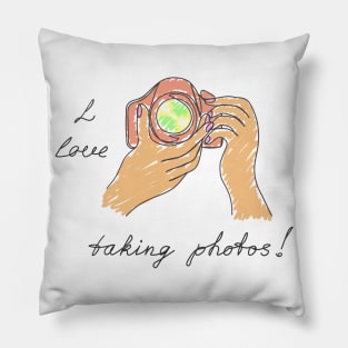 Old camera in hands. Pillow