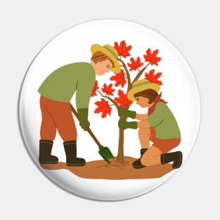 Young couple planting red maple tree. Outdoors gardening concept. Pin