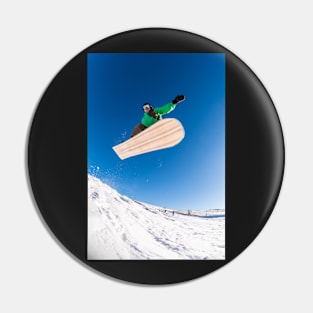 Snowboarder jumping against blue sky Pin