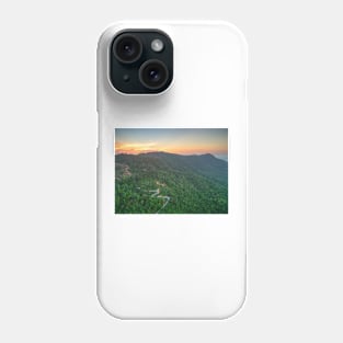 Aerial view of curvy mountain road through a jungle ay sunset Phone Case