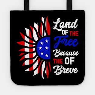 Patriotic Slogan with American Flag Motif, Bold graphic featuring the phrase "Land of the Free Because of the Brave" with an American flag-inspired design. Tote