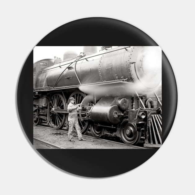 Engineer Oiling Locomotive, 1904. Vintage Photo Pin by historyphoto