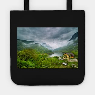 Lake in the mountains on a foggy day Tote