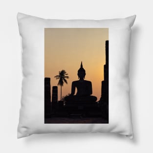 Buddha statue against sunset silhouette Pillow