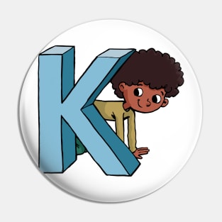 boy is hiding behind the capital letter K Pin