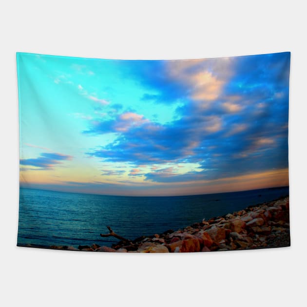 Sunset sky over the rocky beach and the sea Tapestry by KristinaDrozd