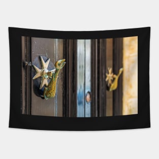 Vintage knockers as dolphin and Maltese cross at black wooden door Tapestry