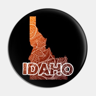 Colorful mandala art map of Idaho with text in brown and orange Pin