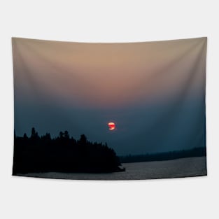 Sunset through a smoky sky Tapestry