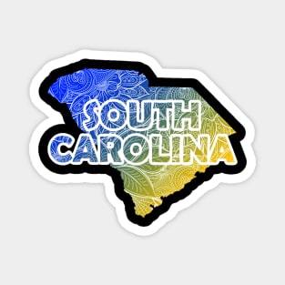 Colorful mandala art map of South Carolina with text in blue and yellow Magnet