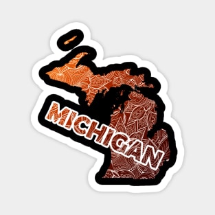 Colorful mandala art map of Michigan with text in brown and orange Magnet