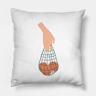 Hand holding a string bag full of fruits Pillow