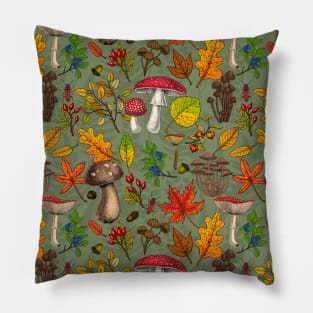 Autumn mushrooms, leaves, nuts and berries on green Pillow