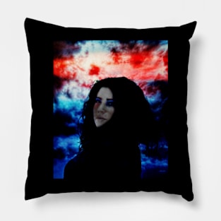 Beautiful girl with dark clothing and hair on dark blue and red clouds background. Pillow