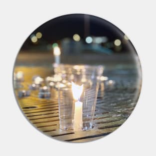 Candles at a Waterfront Vigil Pin