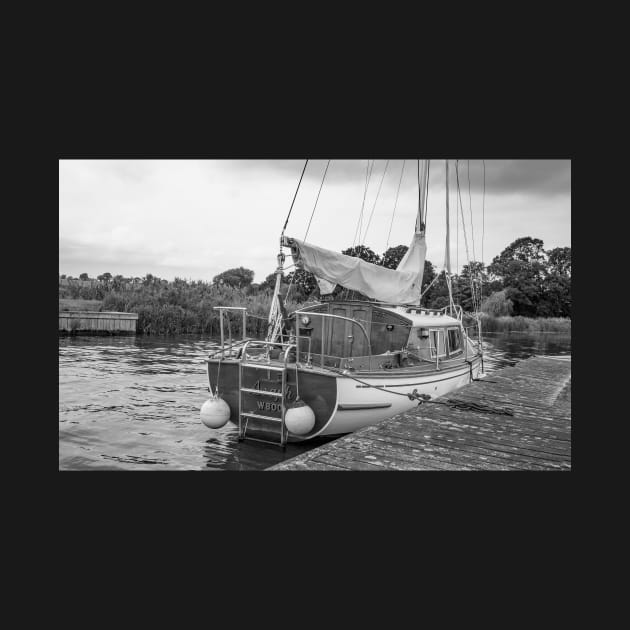 Traditional Broads boat moored to a wooden quay heading by yackers1