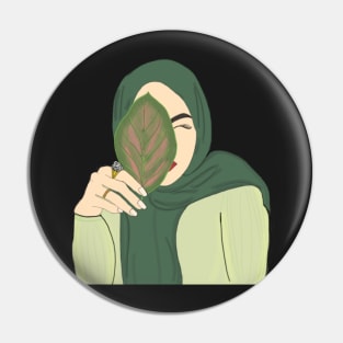 Hijabi Muslim Woman holding a Leaf Pin