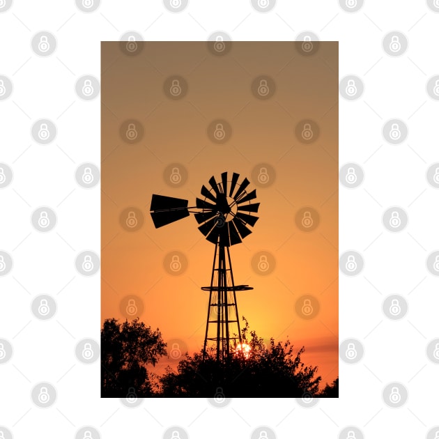 Kansas Golden Sunset with a Windmill silhouette. by ROBERTDBROZEK