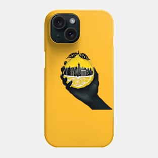 A hand holding a city inside a lemon Phone Case