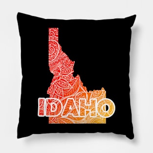 Colorful mandala art map of Idaho with text in red and orange Pillow