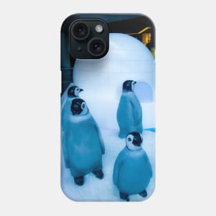 Igloo with a group of penguin sculptures Phone Case